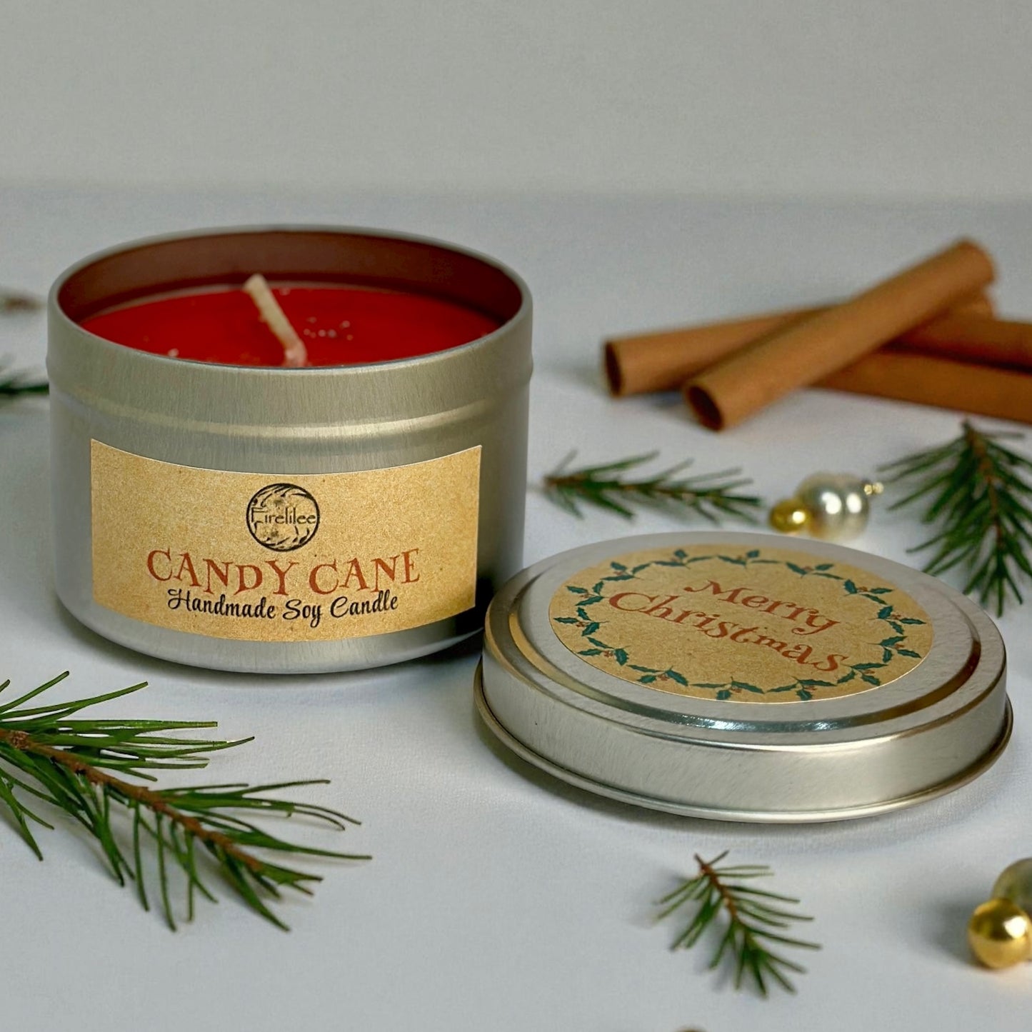 Candy Cane handmade soy candle in a tin with Christmas decorations on a light background